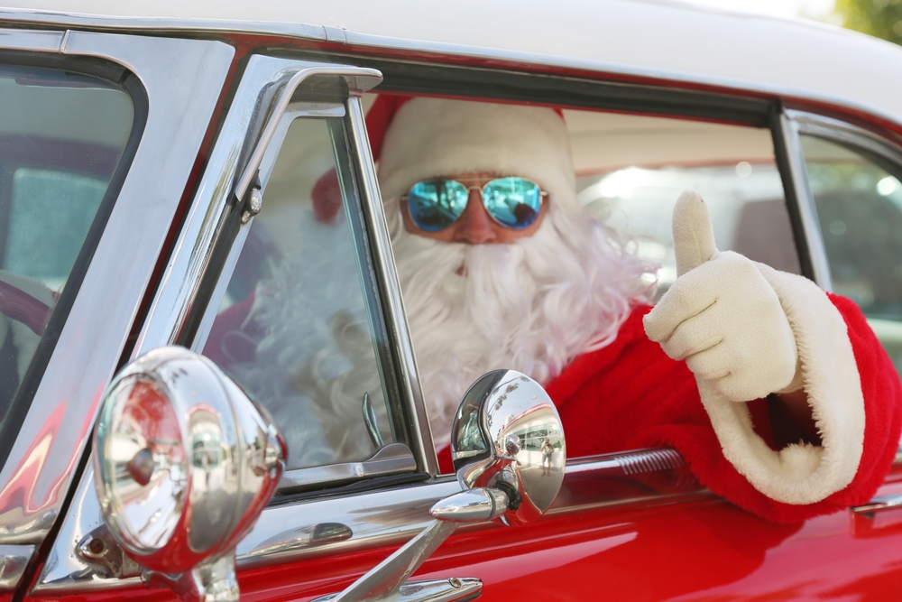 Santa with sun glasses driving car